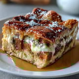 Freshly baked Monte Cristo Breakfast Casserole with Swiss cheese, ham, and turkey layers.