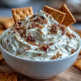 Decadent three-ingredient cheesecake dip served chilled with golden graham crackers for a sweet snack.