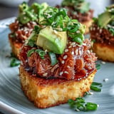 Vibrant crispy rice salad featuring spicy tuna, fresh cucumber, and sesame-dressed avocado for bold Japanese fusion flavor.