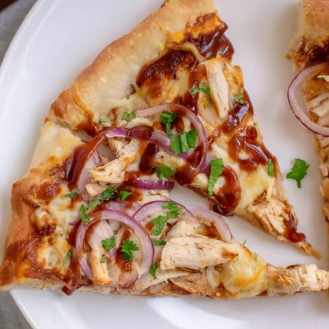 Golden, bubbly Chicken BBQ Pizza featuring smoky grilled chicken and melted cheese, ready to serve.