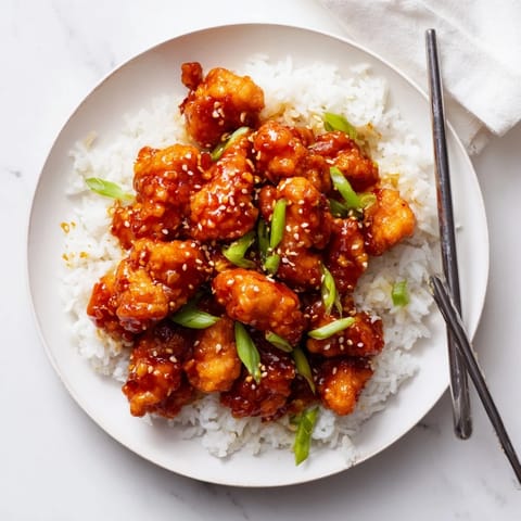 Crispy fried chicken pieces coated in sweet and tangy sauce for a classic takeout-style dinner.