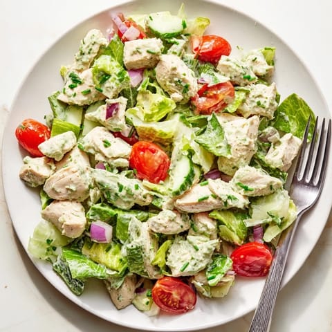 Juicy grilled chicken chunks tossed in creamy avocado ranch dressing with crisp veggies and greens for a refreshing main dish salad.