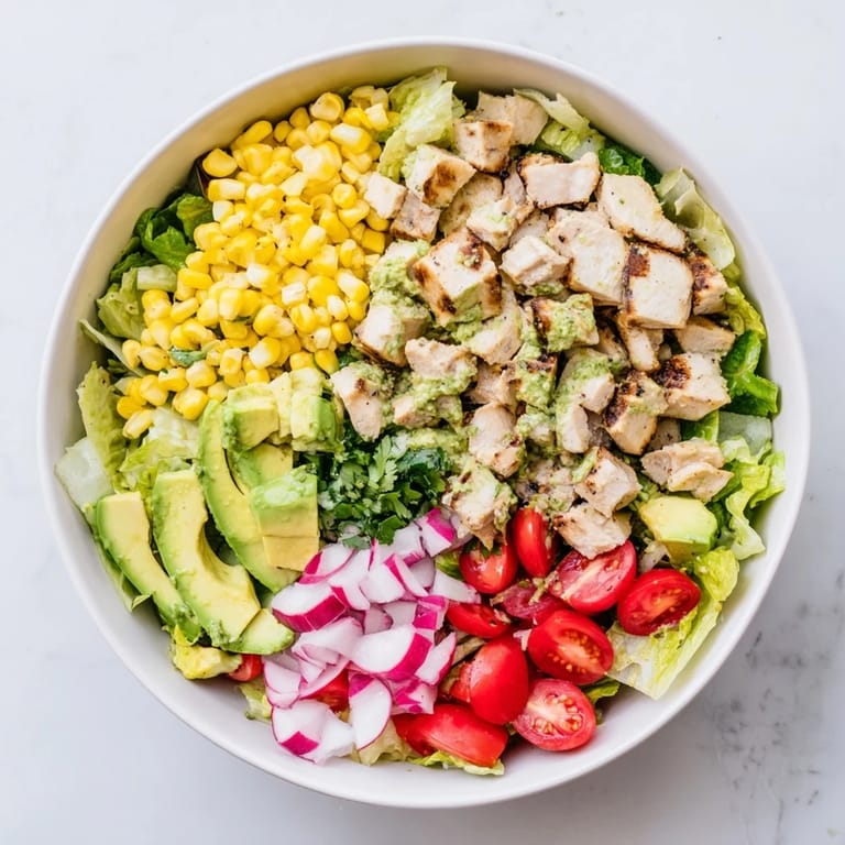 Roasted Corn & Chicken Chopped Salad in a white bowl, with grilled chicken, roasted corn, cherry tomatoes, and fresh cilantro, served as a light and refreshing main dish.